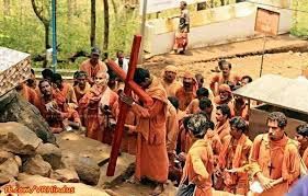 Why wearing saffron robes of Hindu monks but carrying a Cross?