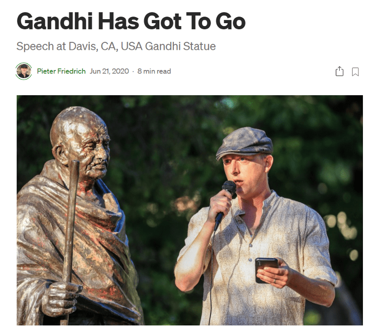 Figure 1: Peter Friedrich speaking in front of Gandhi statue