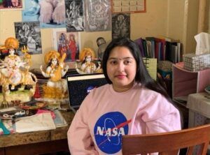 NASA’s intern, Pratima Roy, with Hindu Gods and Goddesses on her table and their photos pinned on the wall.